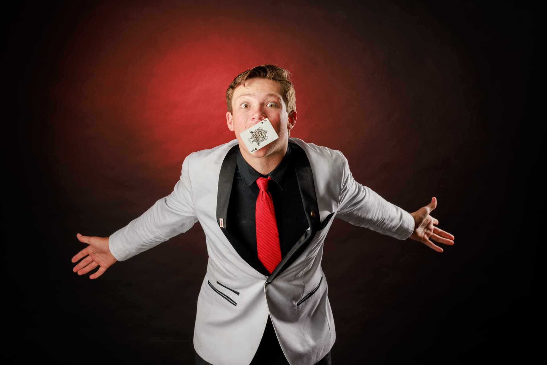 Geno Ploeger with a playing card in his mouth